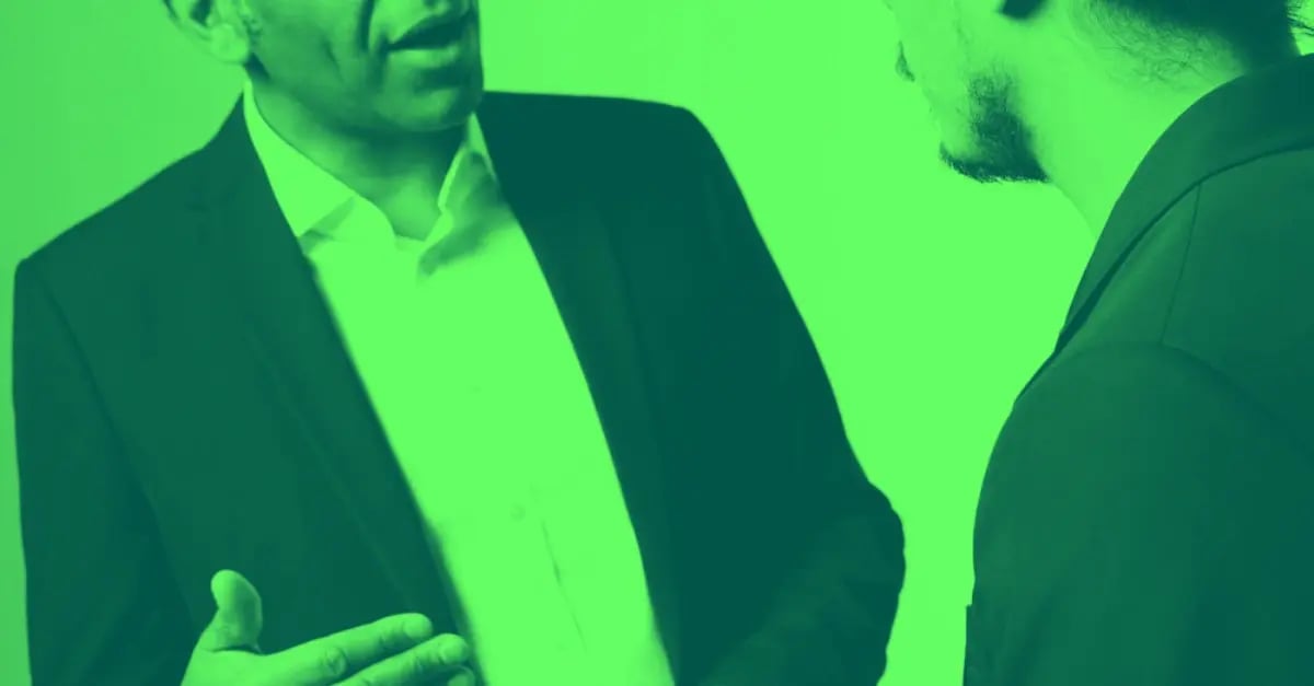 Two men discussing leadership coaching