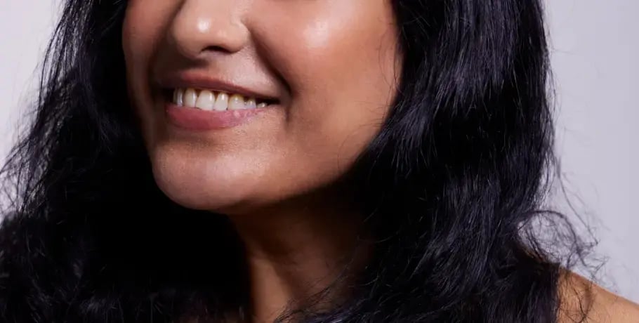 A photo of a woman with dark hair smiling